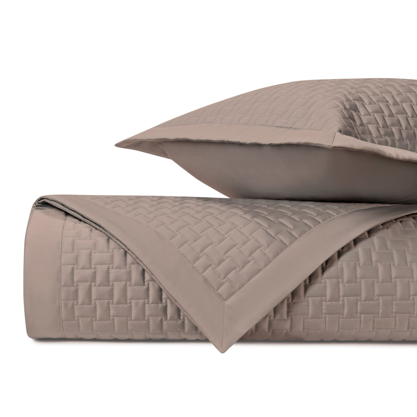 Mink quilted coverlet and sham set with basket-weave stitching and plain border trim.