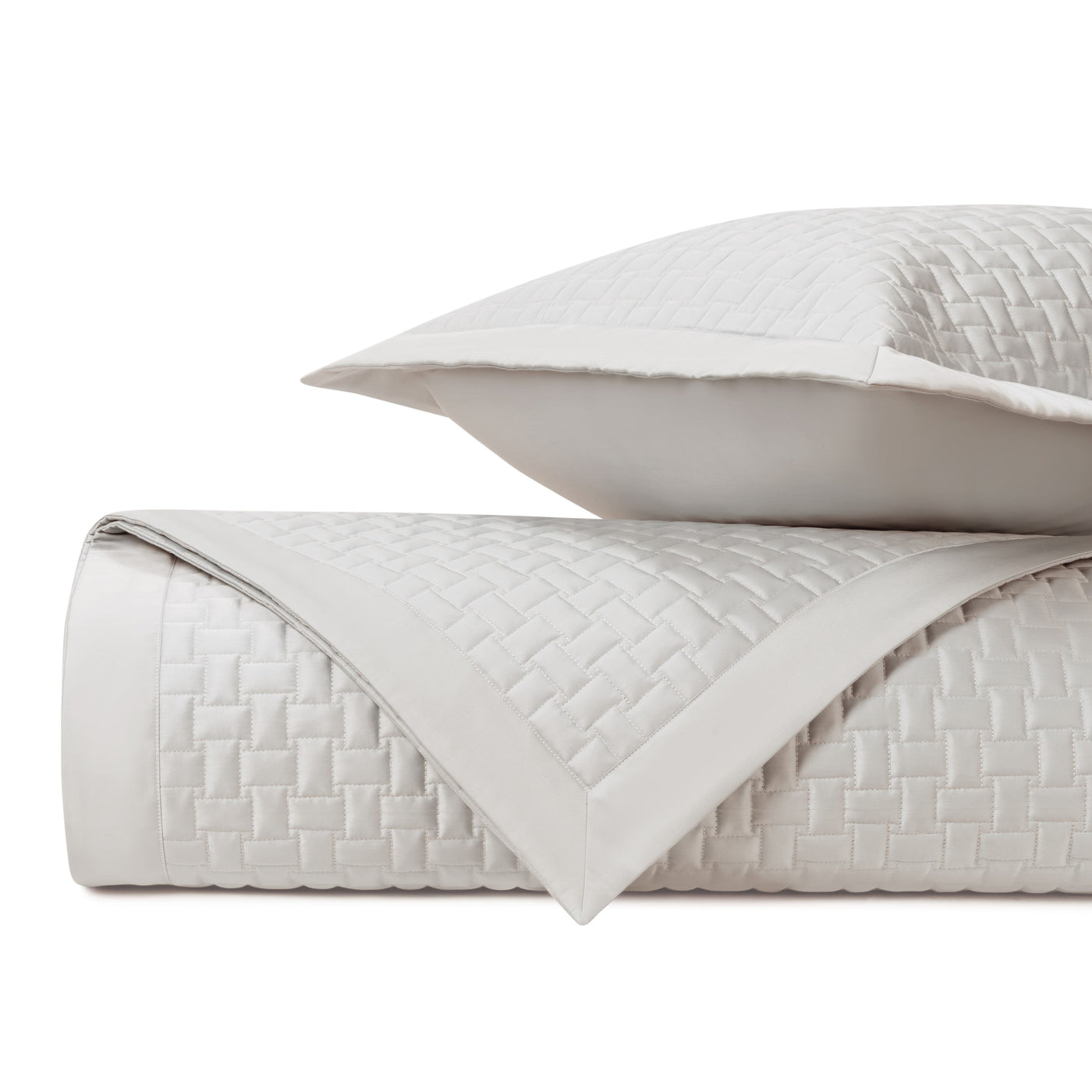 Close-up of ivory quilted basket-weave texture with flat border detail.