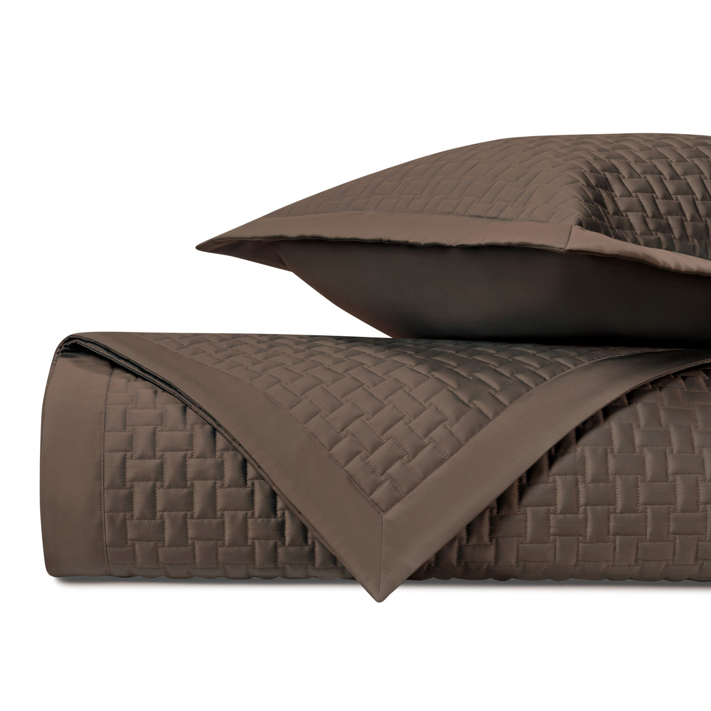 Close-up of chocolate quilted coverlet with basket-weave stitching and matching sham, folded.