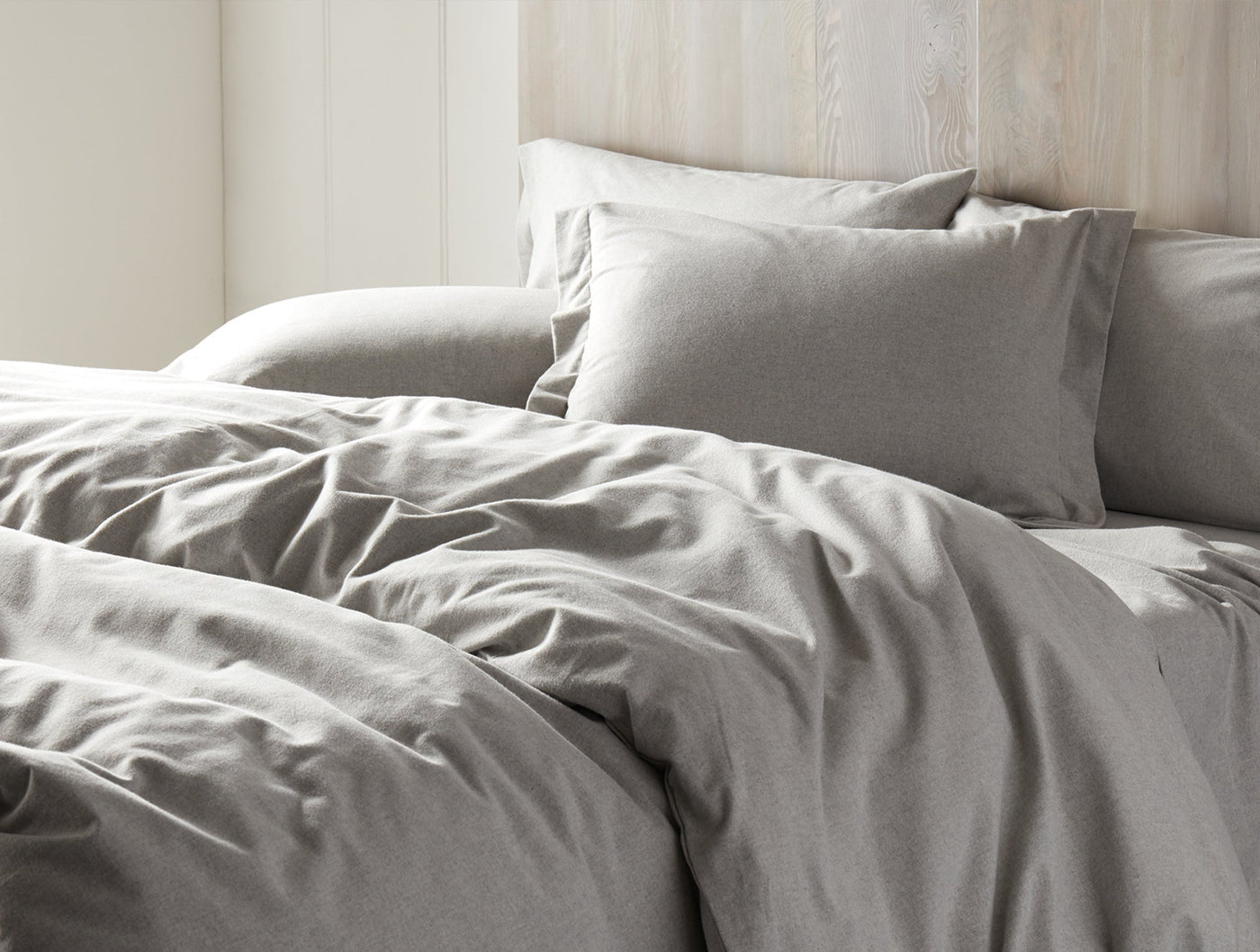 Dove grey flannel sham styled on a bed with matching duvet, soft brushed texture visible.