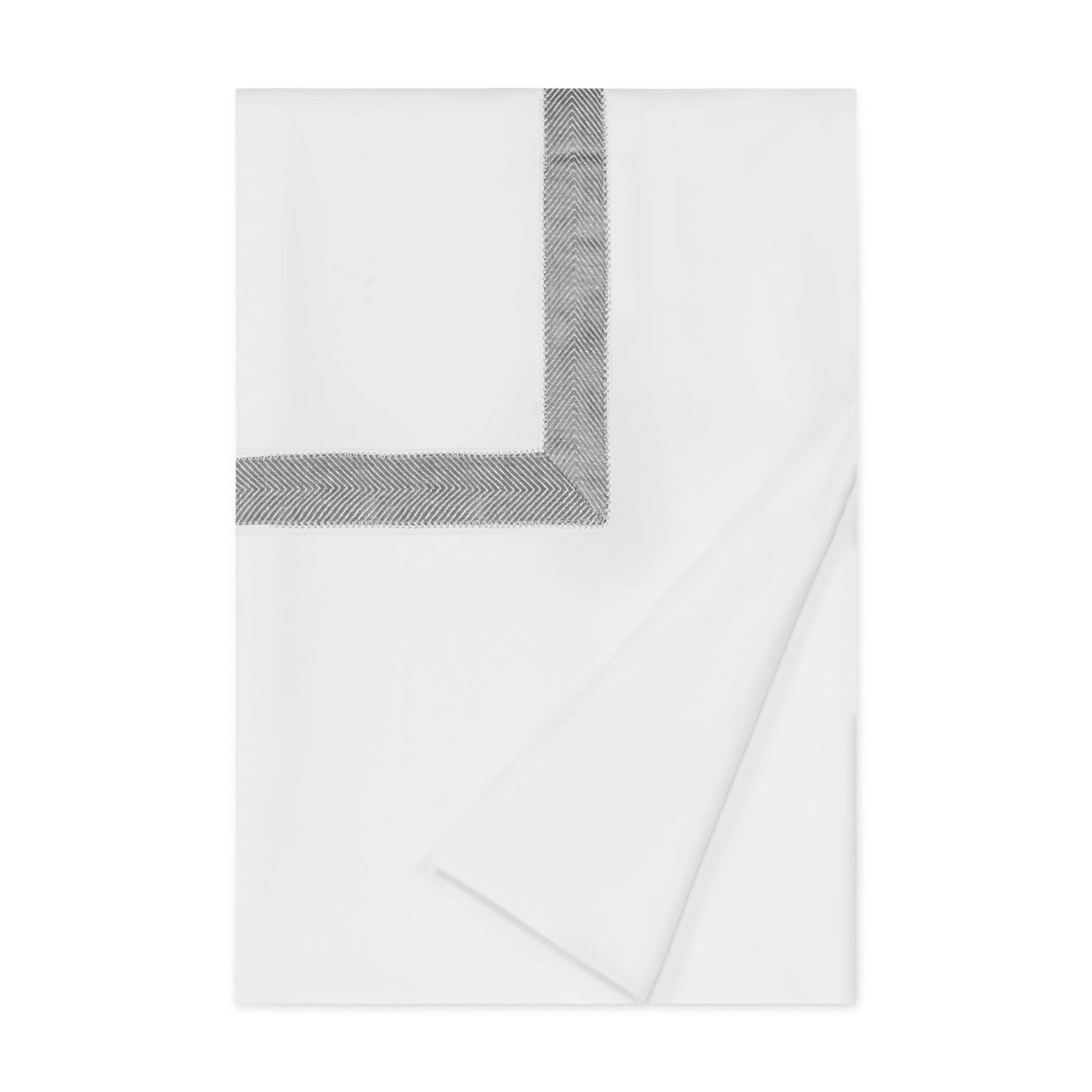 Close-up of folded white duvet cover with charcoal herringbone border trim.
