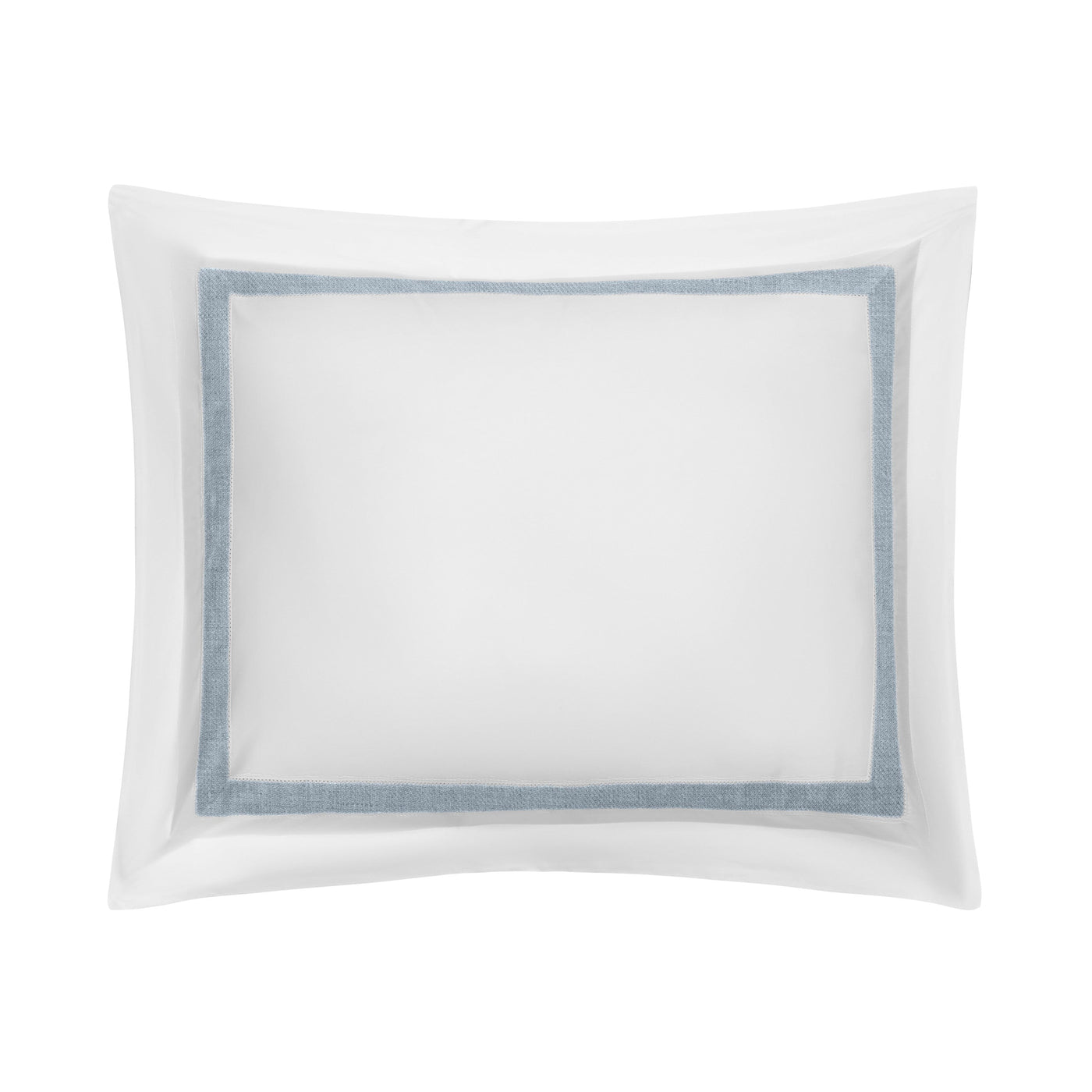 Close-up of white pillow sham with slate blue border trim and flanged edge.
