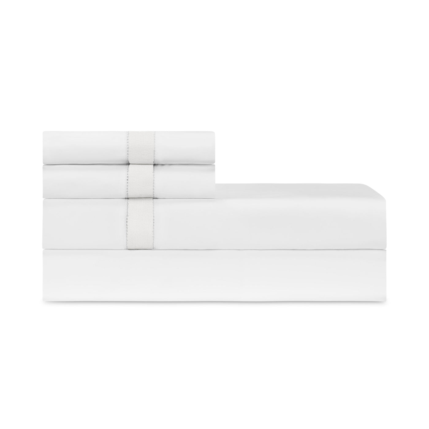 Close-up of folded white Home Treasures Yves sheet set with delicate hemstitch border detail.