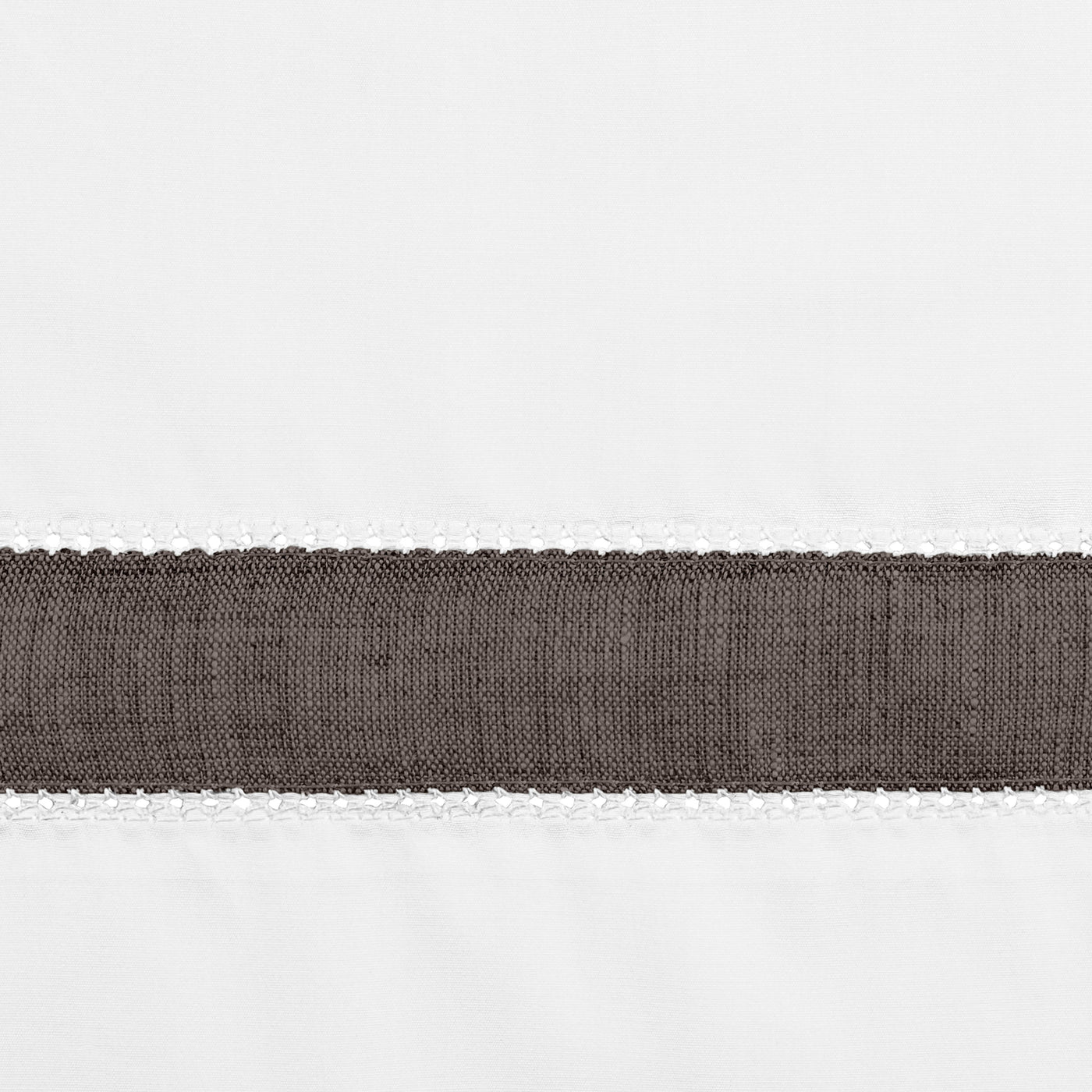 Close-up of charcoal linen band with blanket-stitch trim on white cotton fabric.