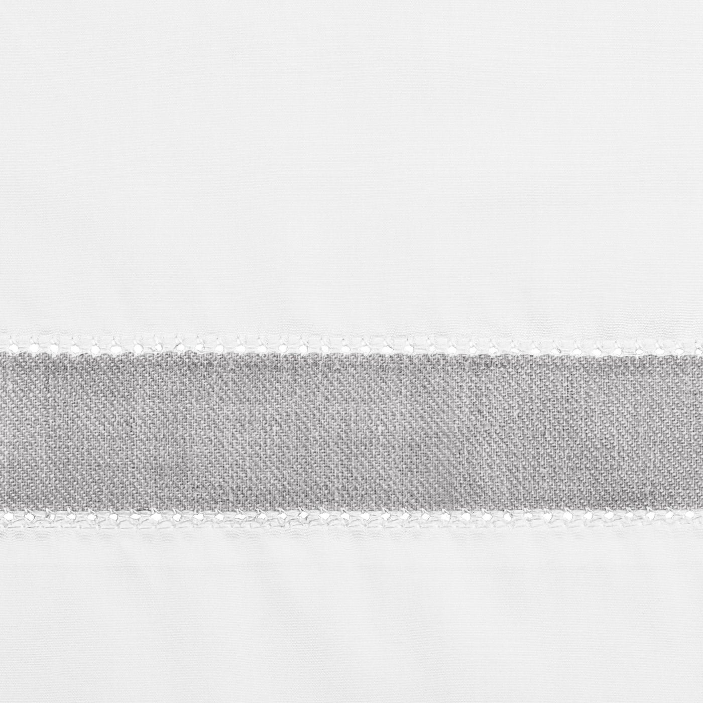 Close-up of grey linen border band with white whipstitch edge on white cotton ground.