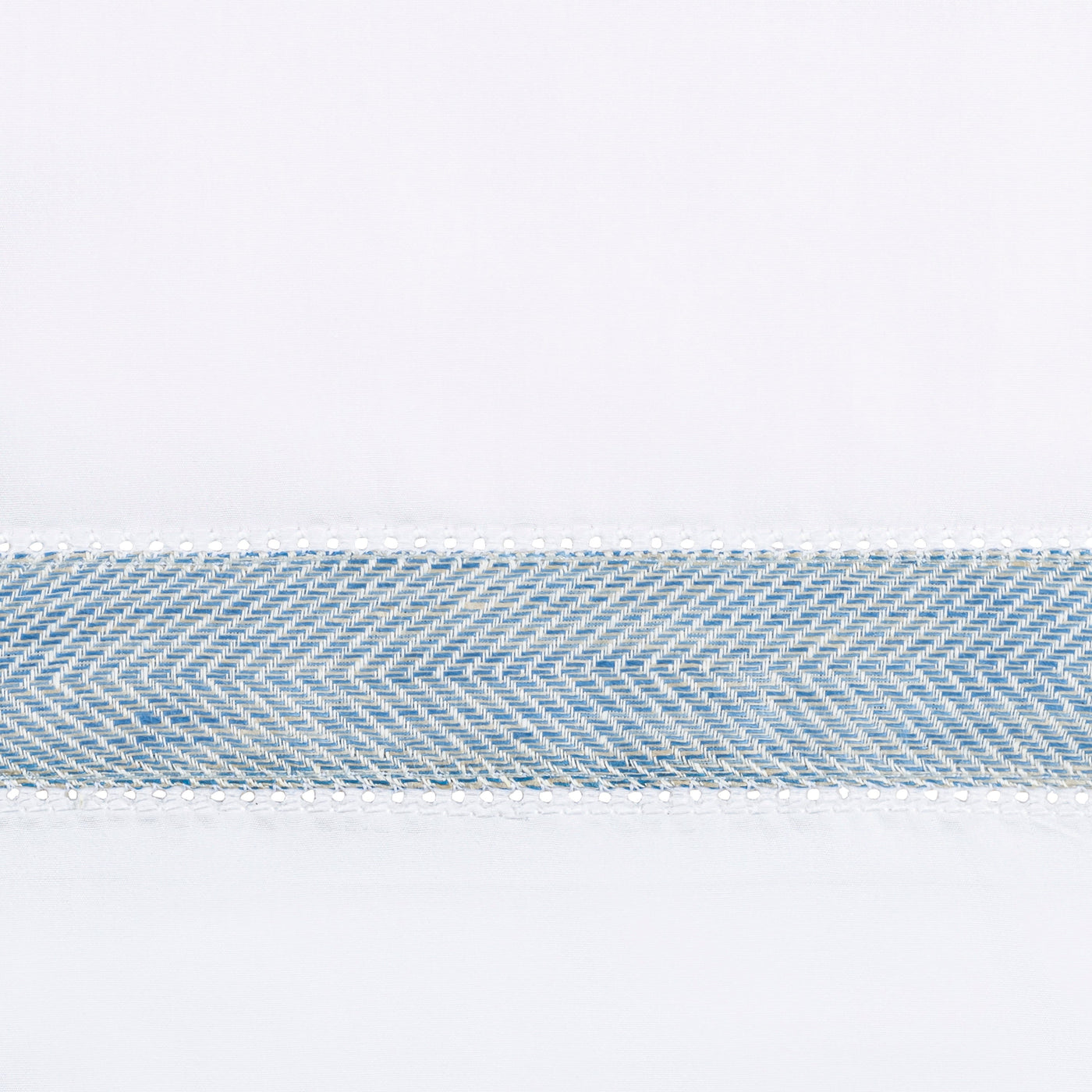 Close-up of sky blue and ivory herringbone woven trim on white linen fabric.