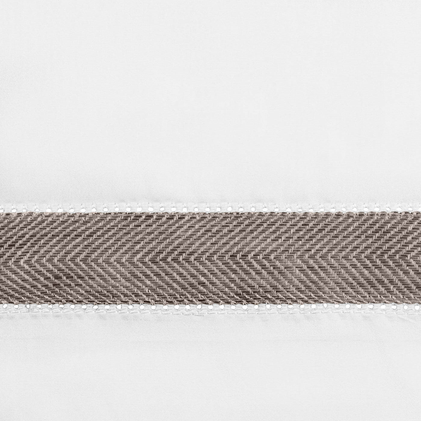 Close-up of taupe herringbone woven trim band on white linen fabric.