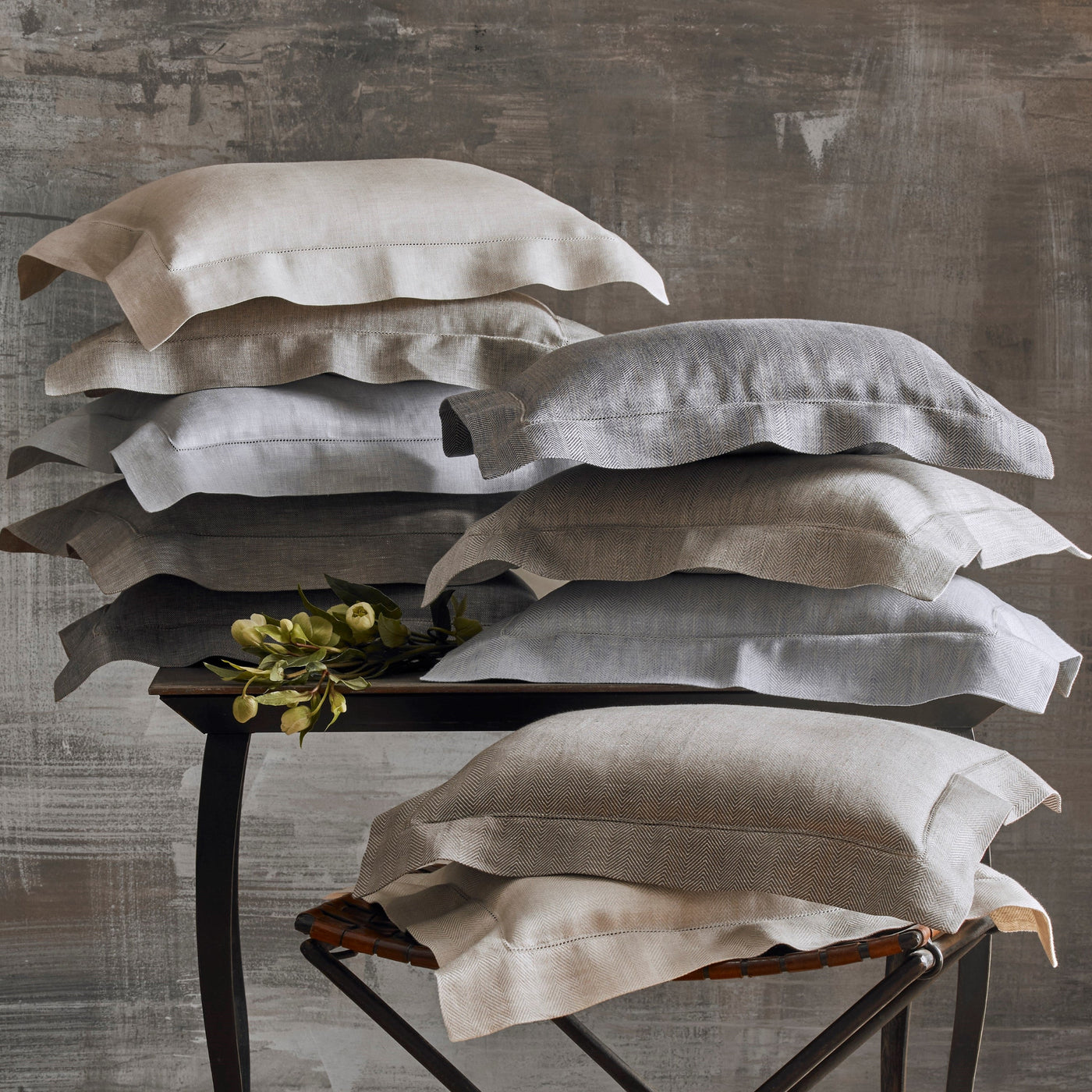 Home Treasures Zebra linen pillow shams stacked in neutral tones on vintage chairs.