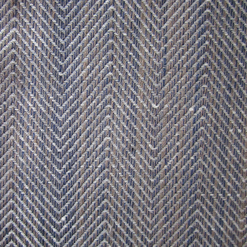 Close-up of navy and ivory herringbone weave texture on linen tablecloth.
