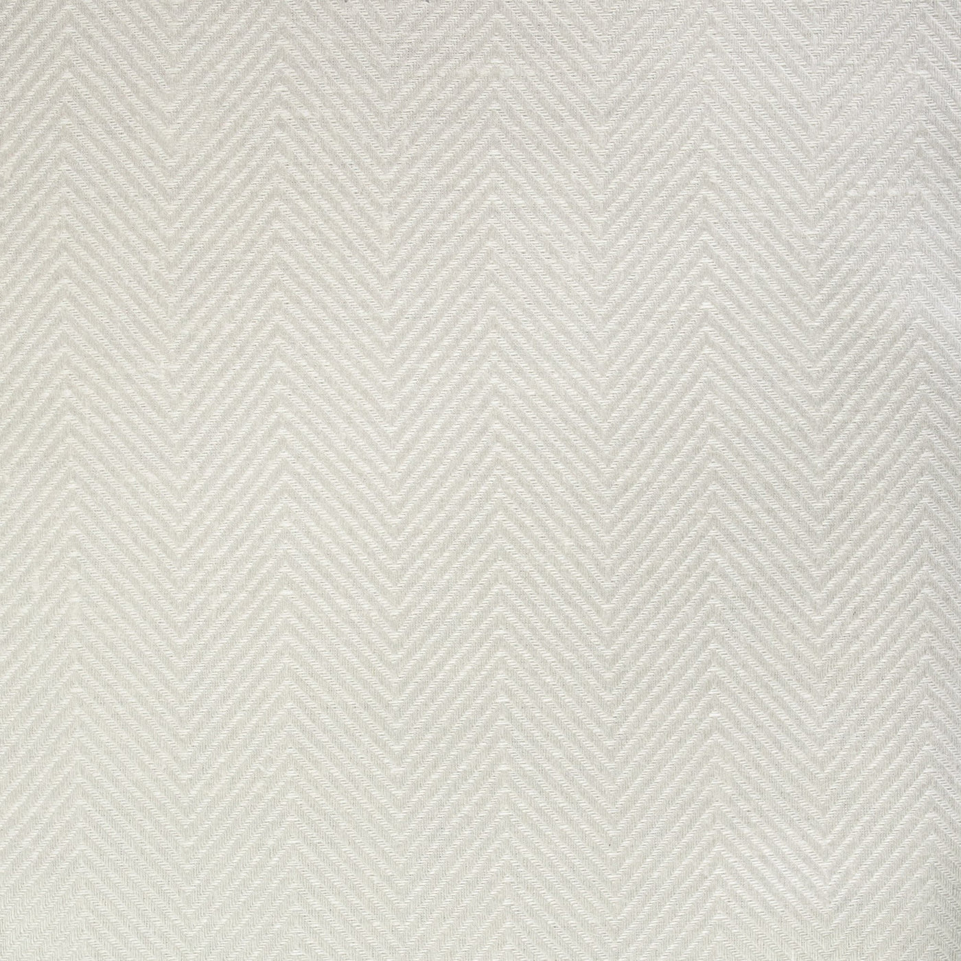 Close-up of ivory herringbone chevron weave texture on quilted coverlet.