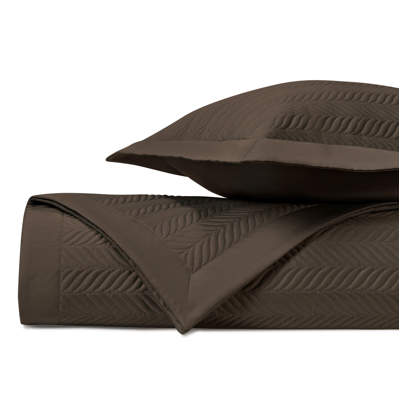 Close-up of chocolate quilted satin with embossed feather-leaf stitching pattern.