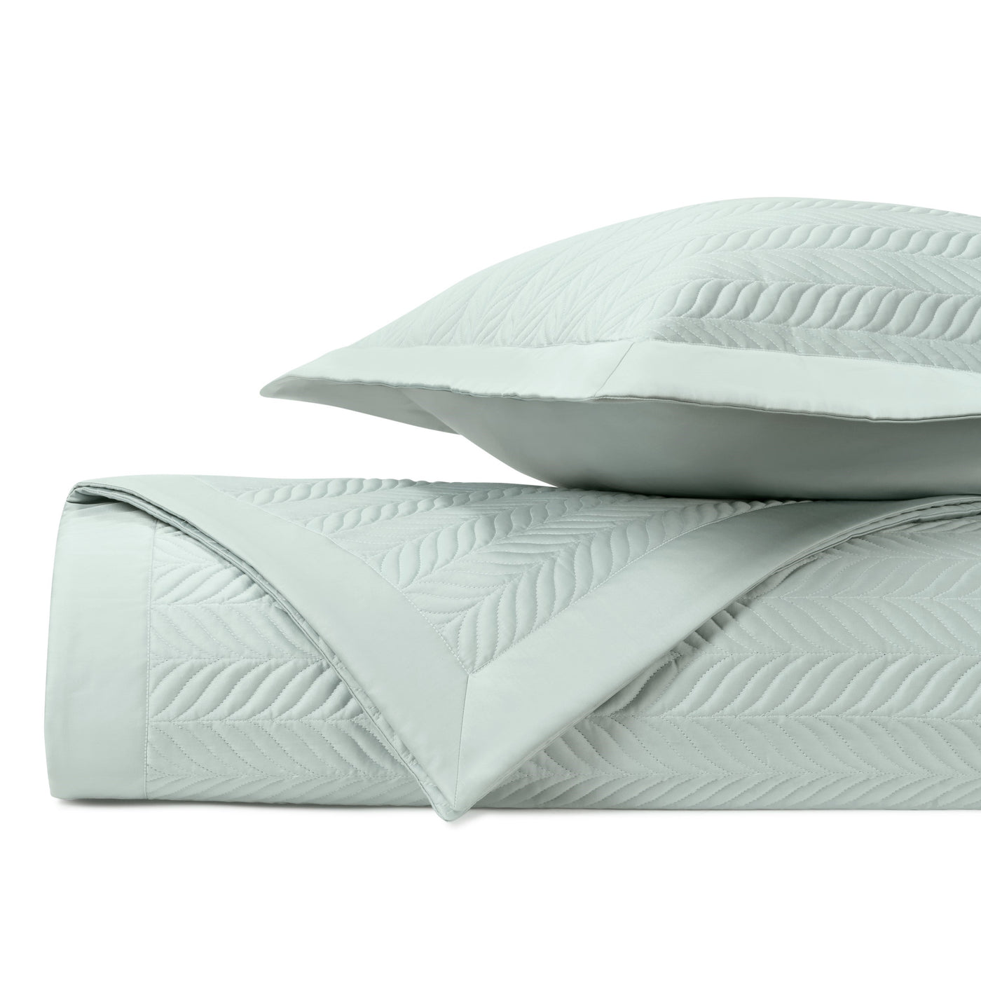 Mist quilted coverlet folded to show embossed leaf-pattern stitching, with matching sham.
