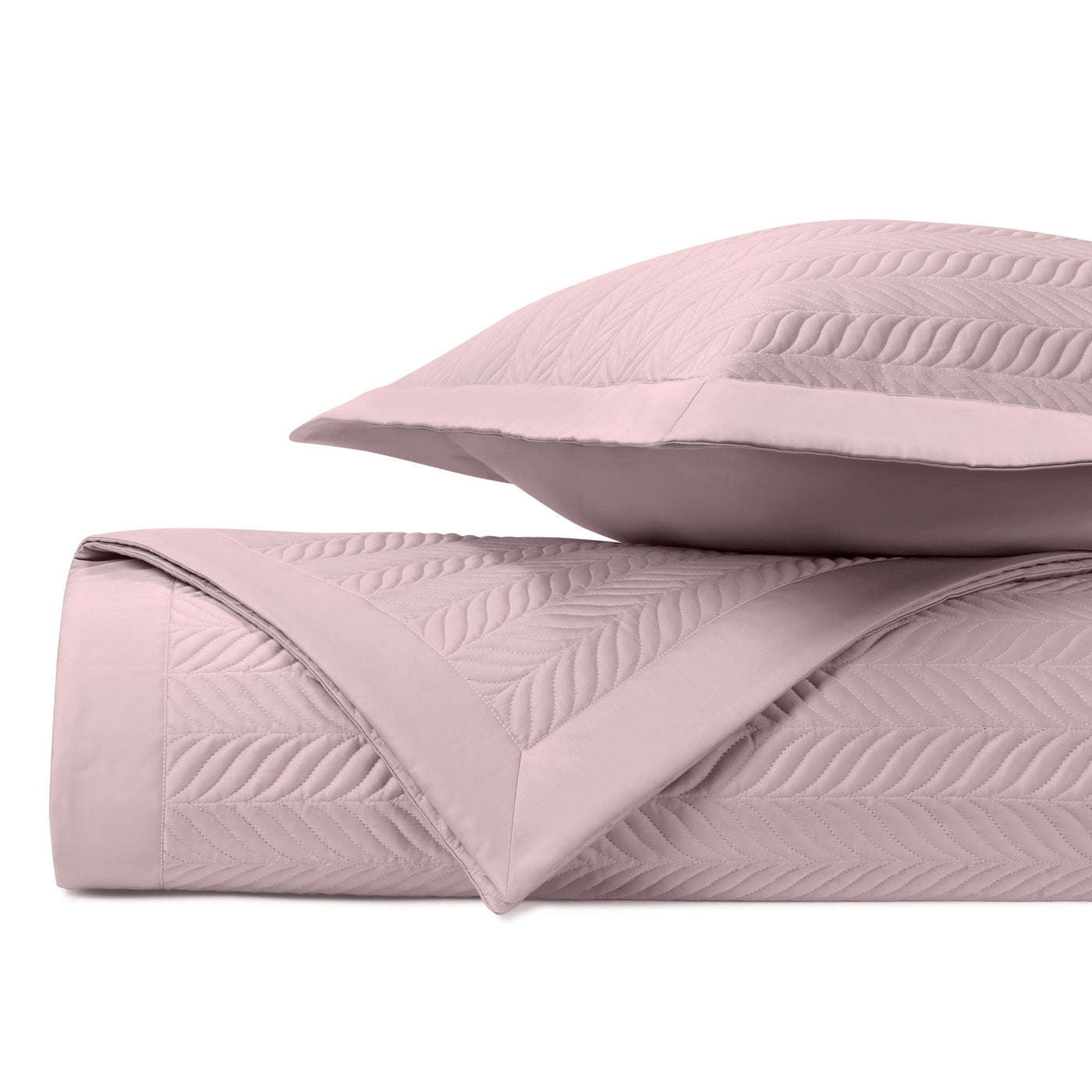 Close-up of Home Treasures Zurich coverlet in blush, showing embossed leaf quilting detail.