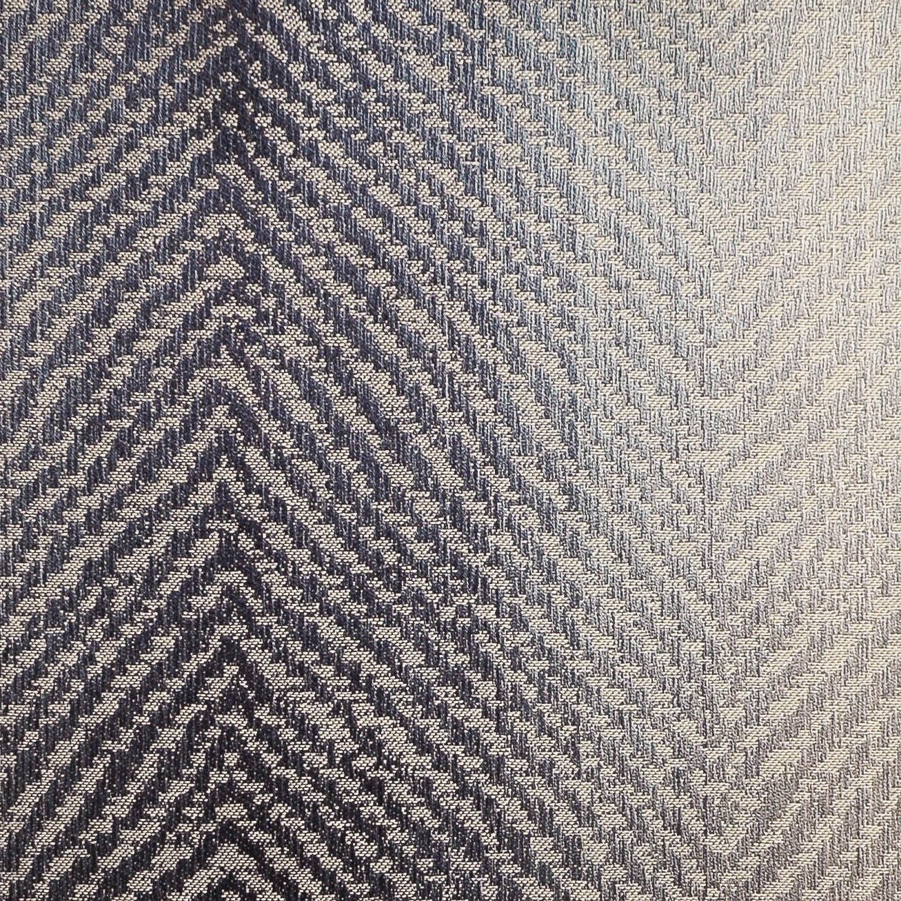 Close-up of Home Treasures Zurich fabric weave in navy and silver herringbone pattern.
