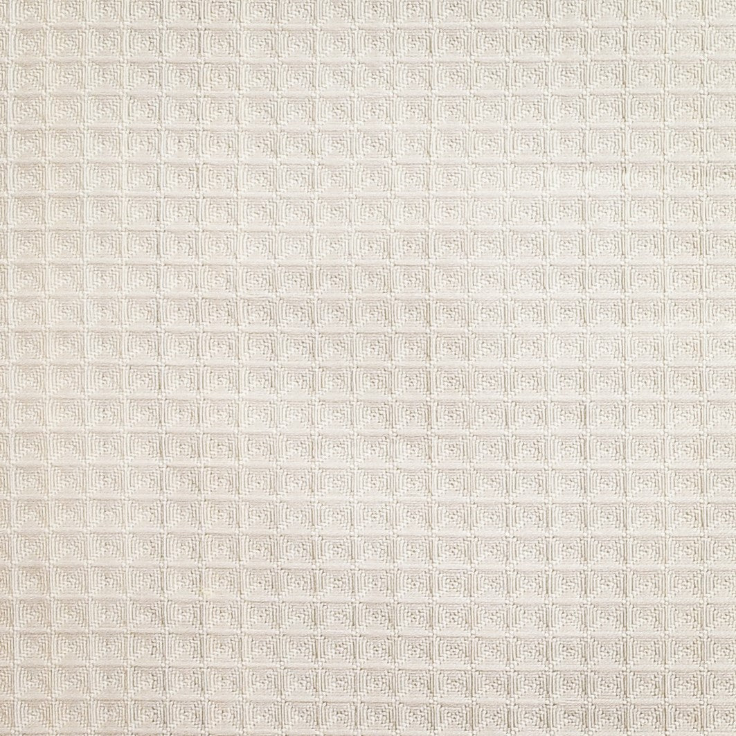 Close-up of ivory waffle-textured cotton fabric on the Zurich bed skirt.