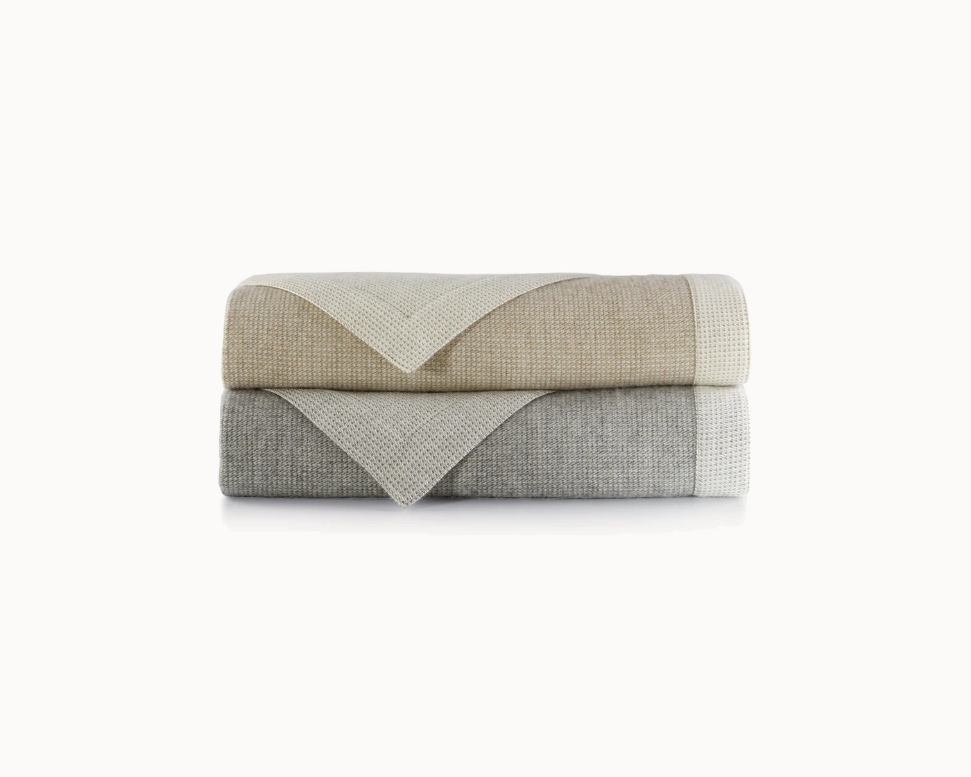 Peacock Alley's Angelo throw in flint and linen, neatly stacked