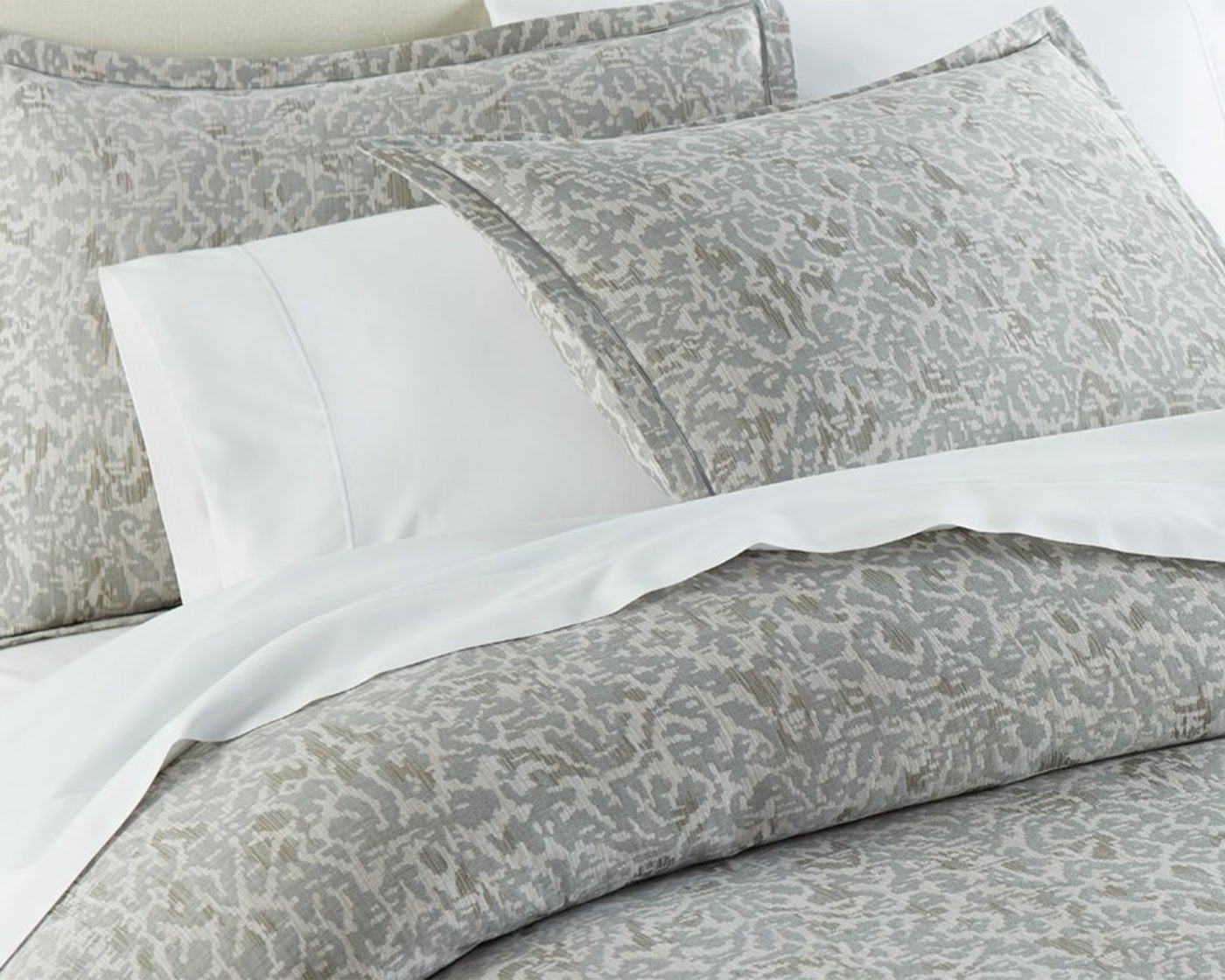 Peacock Alley Ravenna sham and duvet in gray on bed