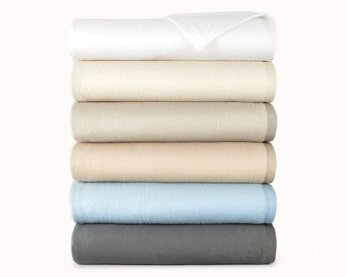  Peacock Alley's All Season blanket neatly stacked in six colors