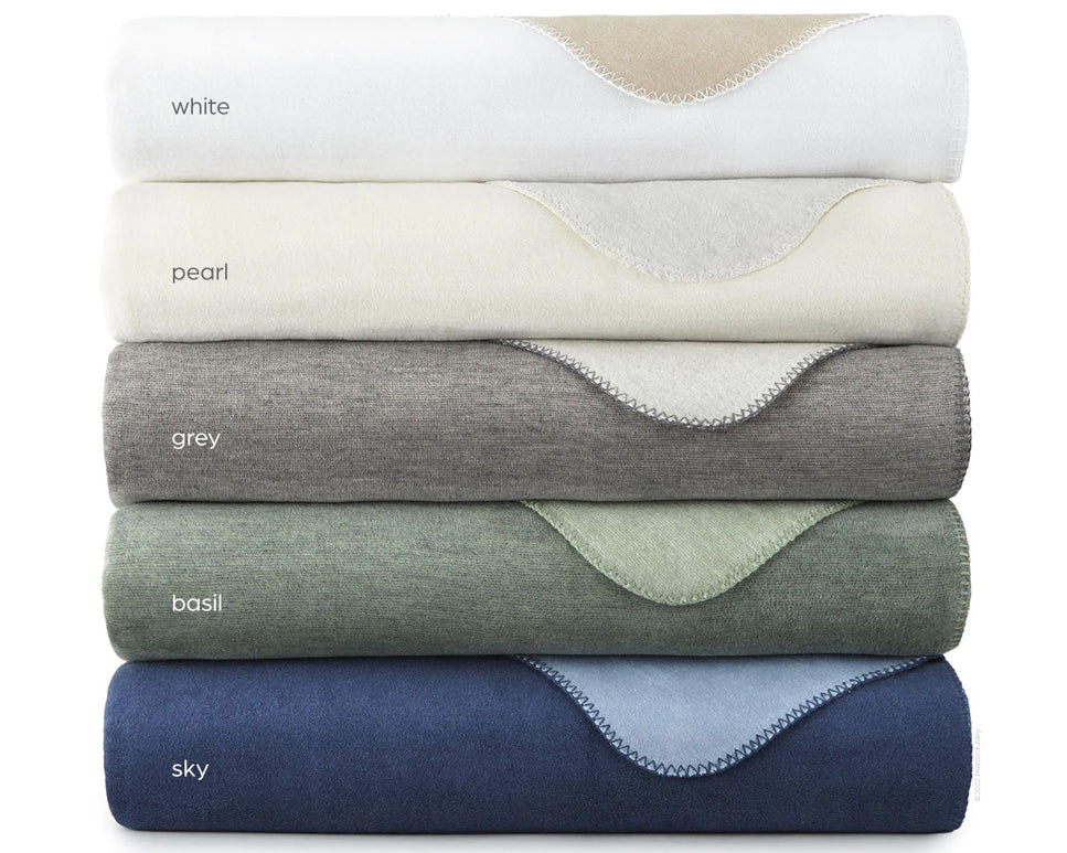 Peacock Alley's Alta blanket in all available colors neatly stacked