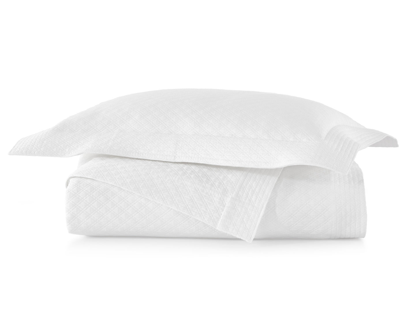 Peacock Alley's Alyssa coverlet and shams in white neatly stacked