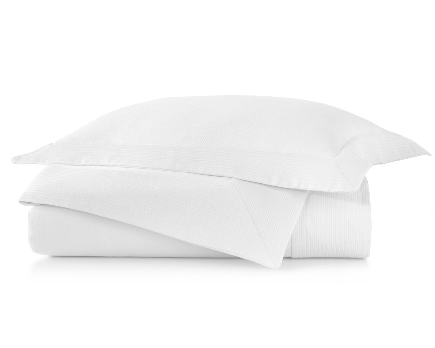 Peacock Alley's Angelina coverlet and shams in white neatly stacked