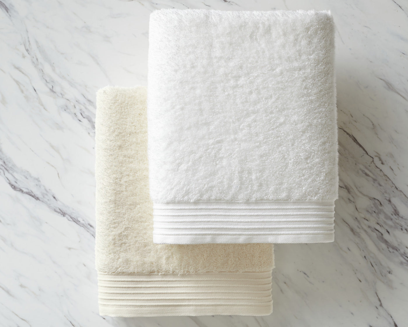 Peacock Alley's Bamboo towels in linen and white, neatly folded