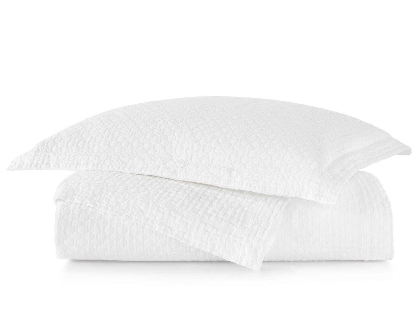 Peacock Alley's Juliet Coverlet and shams in white, neatly stacked