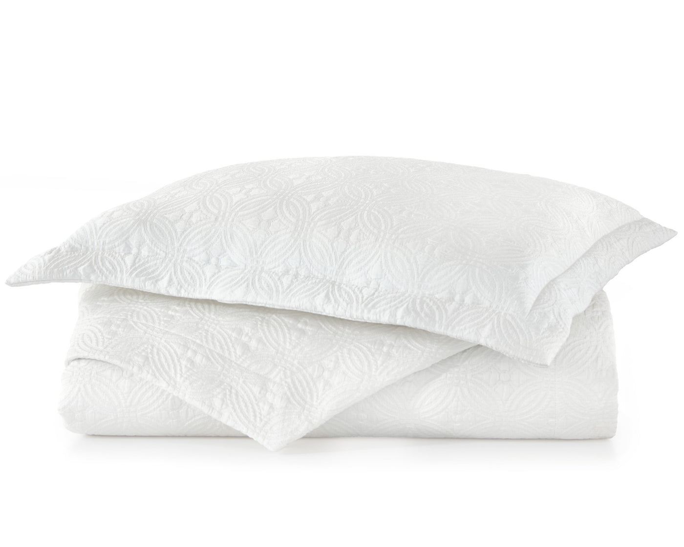 Peacock Alley's Lucia Coverlet and shams in white, neatly stacked