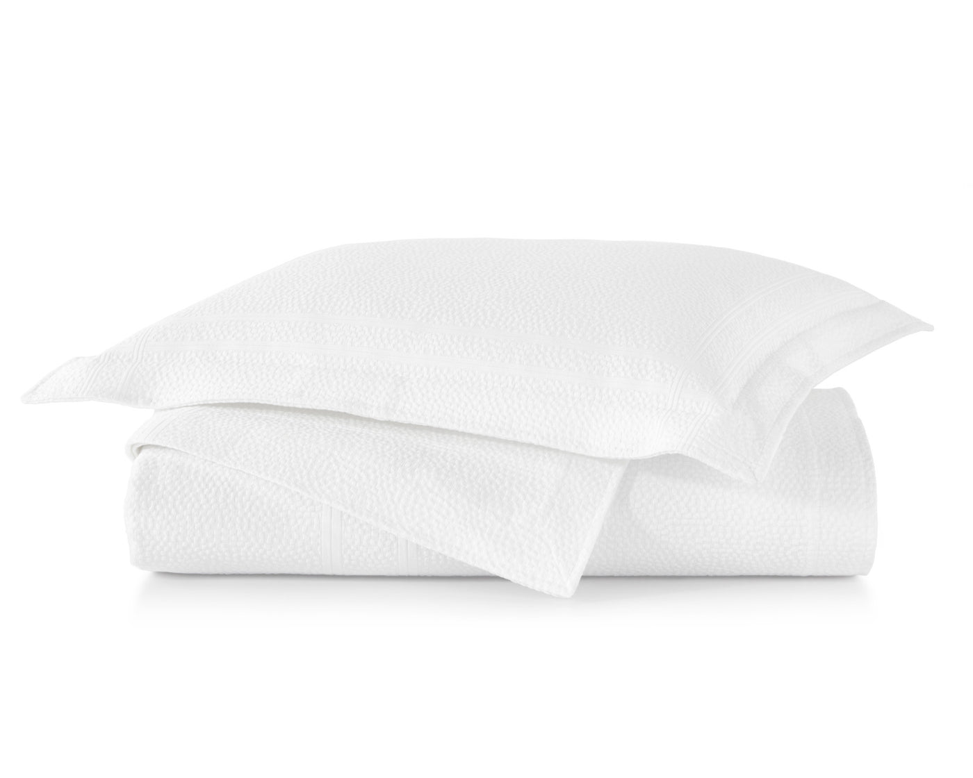 Peacock Alley Montauk sham and coverlet in white, neatly stacked