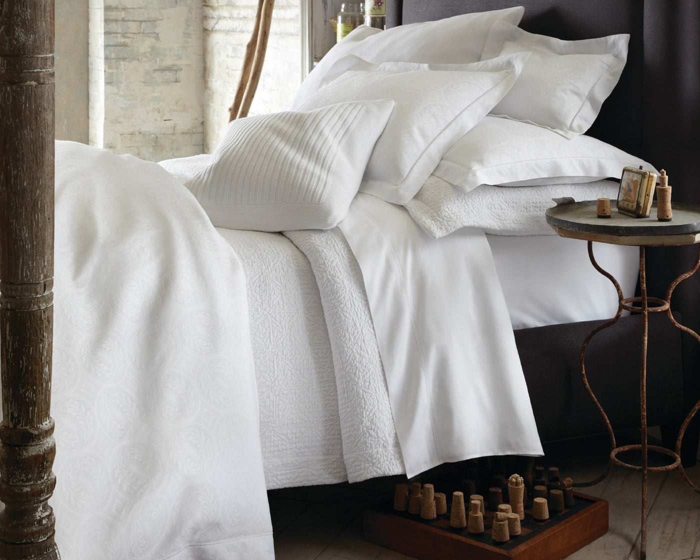 Peacock Alley Vienna Matlesse coverlet and sham in white on luxurious bed